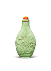 A MOLDED AND CARVED PALE GREEN-GLAZED PORCELAIN SNUFF BOTTLE