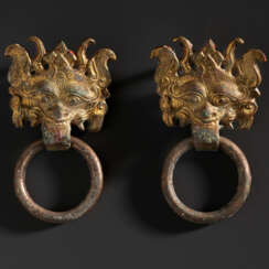 A PAIR OF SMALL GILT-BRONZE TAOTIE MASK FITTINGS