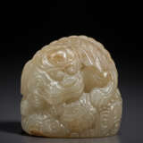 A SMALL GREYISH-BEIGE JADE CARVING OF A BUDDHIST LION - photo 1