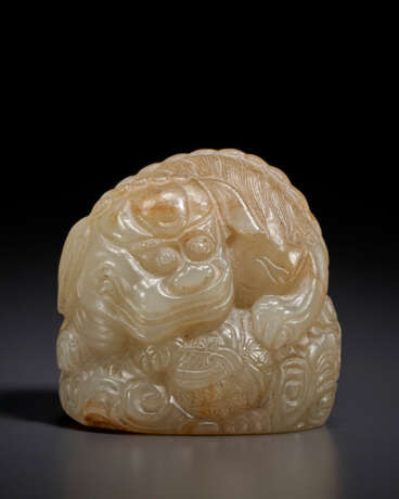 A SMALL GREYISH-BEIGE JADE CARVING OF A BUDDHIST LION - photo 1