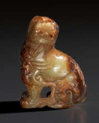 A BEIGE AND BROWN JADE MYTHICAL BEAST