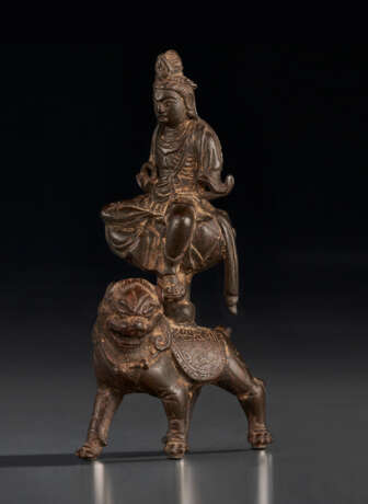 A BRONZE FIGURE OF WENSHU SEATED ON A LION - photo 1