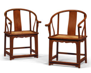 A RARE PAIR OF HUANGHUALI HORSESHOE-BACK ARMCHAIRS