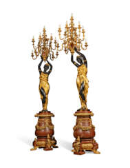 A PAIR OF MONUMENTAL PARCEL-GILT AND PATINATED BRONZE AND ROUGE MARBLE THIRTEEN-LIGHT TORCHERES