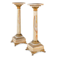 A PAIR OF FRENCH ORMOLU-MOUNTED ONYX PEDESTALS