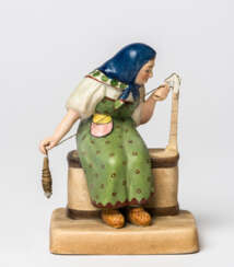 A RUSSIAN PORCELAIN FIGURE SHOWING A FARMER'S WIFE SPINNING