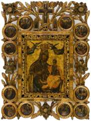 A LARGE GREEK ICON WITH OPENWORK CARVINGS AND WOODEN MEDAILLONS SHOWING THE MOTHER OF GOD PORTAITISSA AND 12 CHURCH FEASTS