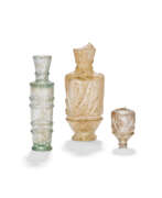 Fatimid dynasty (909-1171). THREE CYLINDRICAL GLASS BOTTLES