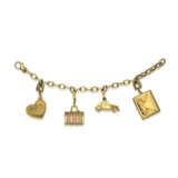 FOUR LOUIS VUITTON CHARMS AND A GOLD BRACELET - фото 1
