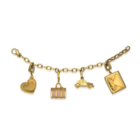 FOUR LOUIS VUITTON CHARMS AND A GOLD BRACELET - фото 1