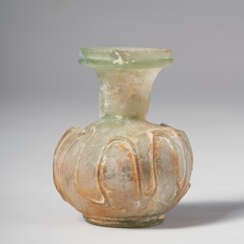 A ROMAN PALE-GREEN GLASS SPRINKLER FLASK WITH APPLIED TRAILING