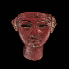 AN EGYPTIAN RED GLASS PORTRAIT HEAD OF THE PHARAOH RAMESES I OR SETI I