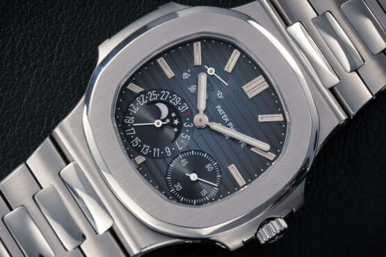 PATEK PHILIPPE, NAUTILUS REF. 5712A, A STEEL AUTOMATIC WRISTWATCH WITH MOON PHASE - фото 1