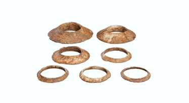 A GROUP OF SEVEN BROWNISH-IVORY-COLORED OPAQUE STONE FLANGED BRACELETS