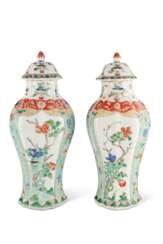 A PAIR OF FAMILLE VERTE OCTAGONAL VASES AND COVERS