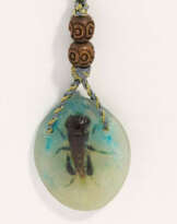 Small oval pendant with insect