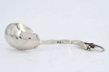 Silver gravy boat and sauce spoon