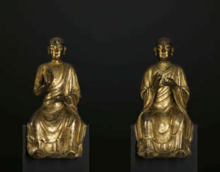 AN EXCEEDINGLY RARE PAIR OF GILT-BRONZE SEATED LUOHAN FIGURES