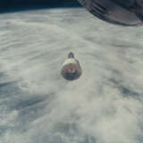 THE GEMINI VII SPACECRAFT OVER THE EARTH AND CLOUDS, DECEMBER 15-16, 1965; ONE OF THREE RENDEZVOUS PHOTOS - фото 1