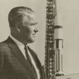 DR. WERNHER VON BRAUN STANDING IN FRONT OF A SATURN 1B ROCKET, 1965 - photo 1