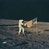 PETE CONRAD HOLDING THE U.S. FLAG ON THE OCEAN OF STORMS, NOVEMBER 19, 1969, EVA 1 - photo 1