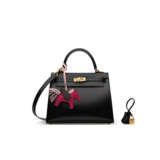 A SET OF TWO: A BLACK CALF BOX LEATHER SELLIER KELLY 25 WITH GOLD HARDWARE & A PEGASUS ROD&#201;O CHARM PM - photo 1