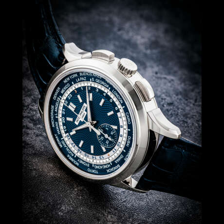PATEK PHILIPPE. AN 18K WHITE GOLD AUTOMATIC FLYBACK CHRONOGRAPH WRISTWATCH WITH WORLDTIME DISPLAY - photo 1