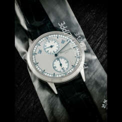 PATEK PHILIPPE. AN 18K WHITE GOLD AUTOMATIC ANNUAL CALENDAR WRISTWATCH WITH REGULATOR-STYLE DIAL, SINGLE SEALED