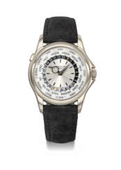 PATEK PHILIPPE. AN ATTRACTIVE 18K WHITE GOLD AUTOMATIC WORLD TIME WRISTWATCH WITH CERTIFICATE OF ORIGIN AND BOX