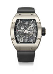 RICHARD MILLE. A RARE AND ATTRACTIVE TITANIUM TONNEAU-SHAPED AUTOMATIC SKELETONIZED WRISTWATCH WITH SWEEP CENTRE SECONDS AND DATE