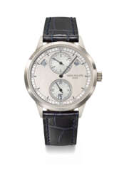 PATEK PHILIPPE. AN ATTRACTIVE 18K WHITE GOLD AUTOMATIC ANNUAL CALENDAR WRISTWATCH WITH REGULATOR-STYLE DIAL, CERTIFICATE OF ORIGIN AND BOX