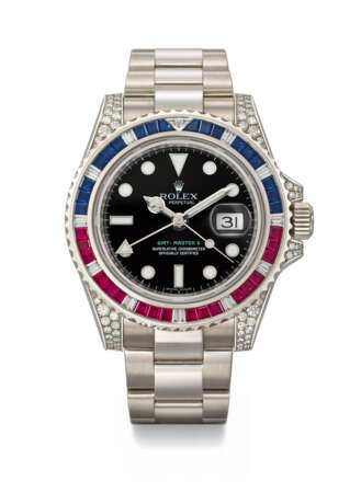 ROLEX. A RARE AND ATTRACTIVE 18K WHITE GOLD, DIAMOND, RUBY AND SAPPHIRE-SET AUTOMATIC DUAL TIME WRISTWATCH WITH SWEEP CENTRE SECONDS, DATE, BRACELET, GUARANTEE AND BOX - photo 1