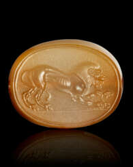 A GREEK BROWN CHALCEDONY SCARABOID WITH A LION AND SERPENT