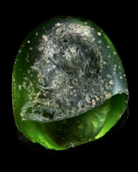 A FRAGMENTARY GREEK GREEN GLASS RINGSTONE WITH A GODDESS