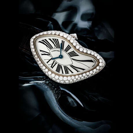 CARTIER. A RARE 18K WHITE GOLD AND DIAMOND-SET LIMITED EDITION ASYMMETRICAL WRISTWATCH - photo 1