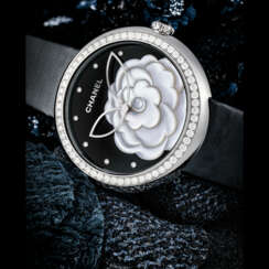 CHANEL. A LADY’S ATTRACTIVE 18K WHITE GOLD AND DIAMOND-SET WRISTWATCH WITH ONYX AND MOTHER-OF-PEARL DIAL