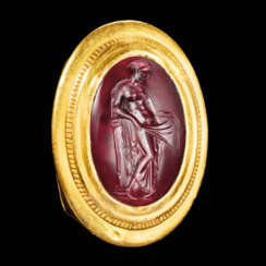 A GREEK GOLD AND GARNET FINGER RING WITH DANAE