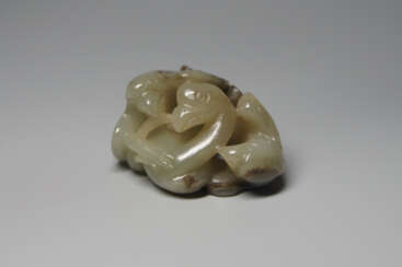 A JADE ORNAMENT OF TWO HAIDONGQIN BIRDS PECKING A GOOSE OF LIAO/JIN DYNASTY