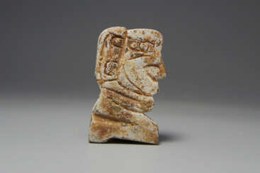 A JADE KNEELING HUMAN OF SHANG DYNASTY (1600-1046BC)