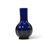 A TRANSLUCENT BLUE GLASS FLUTED BOTTLE VASE - фото 1