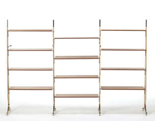 Three-span bookcase with uprights in black painted steel and wood covered in synthetic leather, feet in solid brass. Twelve height-adjustable shelves in veneered wood. Italy, 1960s. (252x171x41 cm.) (slight defects)