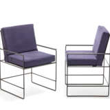 Pair of outdoor armchairs with black painted iron structure and removable cushions covered in blue fabric. - photo 1
