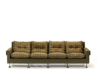 Four seater sofa with removable armrests and backrest. Steel feet, green fabric upholstery and padded cushions covered in fabric with circular motifs in shades of green and beige. Italy, 1970s. (267x75x90 cm.) (slight defects)
