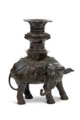 A BRONZE MODEL OF AN ELEPHANT AND VASE