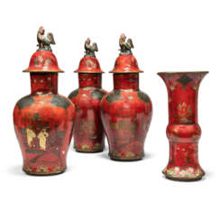 A GARNITURE OF THREE CONTINENTAL RED, BLACK AND PARCEL GILT JAPANNED FAYENCE BALUSTER VASES AND COVERS AND A FLARED BEAKER VASE