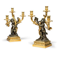 A PAIR OF RESTAURATION PATINATED-BRONZE AND ORMOLU THREE-BRANCH CANDELABRA