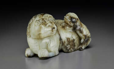 A PALE AND DARK GREY JADE CARVING OF A LION WITH CUB