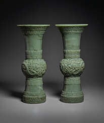 A RARE AND SUPERB PAIR OF FINELY CARVED GREEN JADE GU-FORM VASES