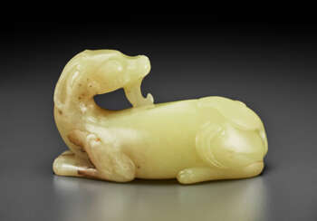 A PALE YELLOW JADE FIGURE OF A RECUMBENT MYTHICAL BEAST