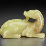 A PALE YELLOW JADE FIGURE OF A RECUMBENT MYTHICAL BEAST - photo 4
